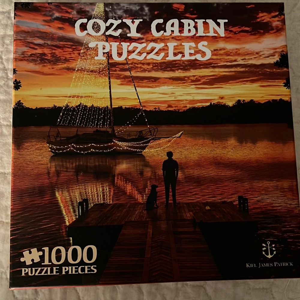 Kiel James Patrick Cozy Cabin 1000 Pieces! The outside plastic is no longer on